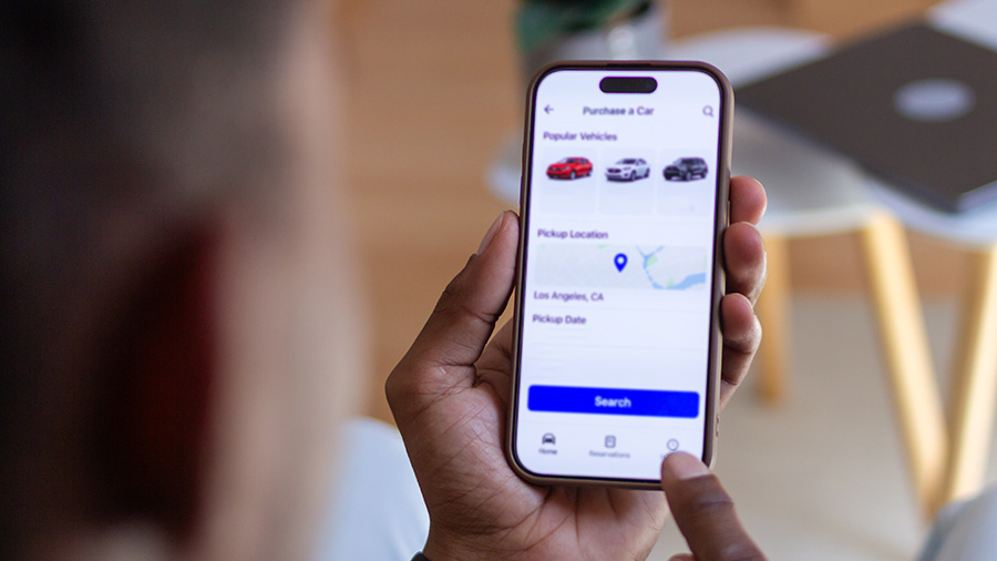 person-holding-phone-with-car-data